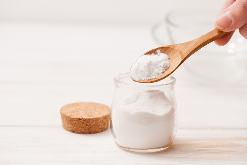 sea salt, starch in the jar and wooden spoon for recipes of cosmetics at home on a white wooden back...