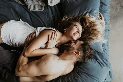 Beautiful loving couple kissing in bed