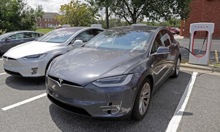 In this July 19, 2019, photo people wait inside their Tesla vehicles at a Tesla Supercharger site in...