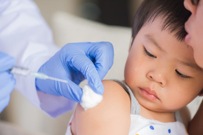 Doctor giving an injection vaccine to a girl. 