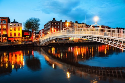 Dublin, Ireland. Night view of famous illuminated Ha Penny Bridge in Dublin, Ireland