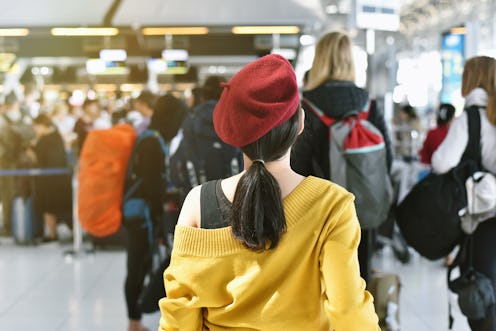 Airline check-in counter queue at international airport with blurred of crowded passenger background...