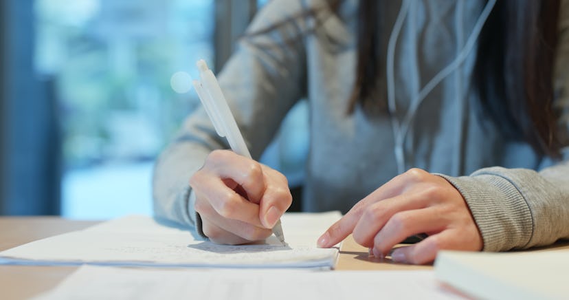 Woman write on the note at the library