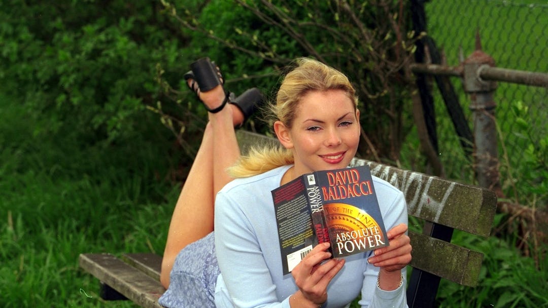 Model Judy Long Poses With The Paperback Of Absolute Power By David Baldacci For A Scottish Daily Ma...