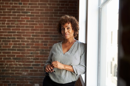 Mature Businesswoman Standing By Office Window