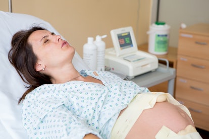 Pregnant woman in delivery room, having contractions
