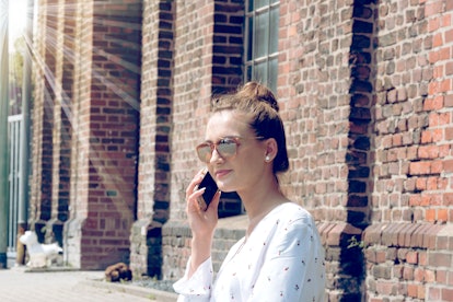 A young woman is on the phone with a smartphone