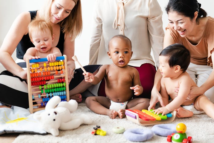 Moms and babies playing with toys