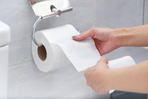 Close-up of Hand Using Toilet Paper.