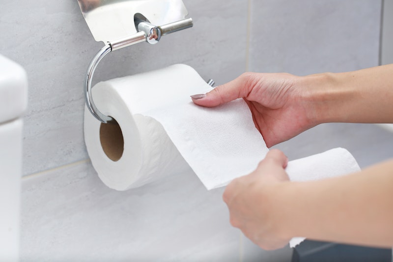 Close-up of Hand Using Toilet Paper.