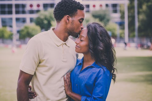 Closeup portrait of a young couple, guy holding woman and kissing face, happy moments, positive huma...