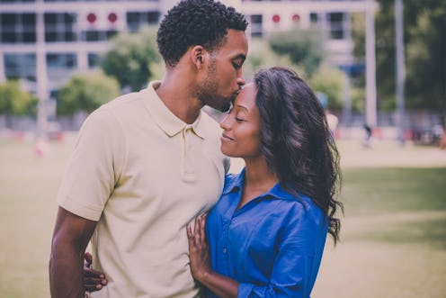 Closeup portrait of a young couple, guy holding woman and kissing face, happy moments, positive huma...