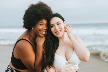 Cheerful beautiful plus size women at the beach