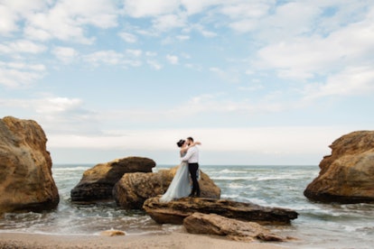 Blurred image of wedding couple by the sea. Wedding sea background