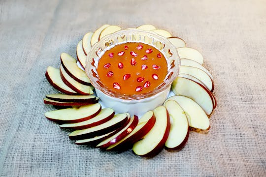 Symbols of the holiday of Rosh Hashanah (Jewish New Year): honey, apple, pomegranate. Tradition Jewi...