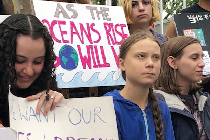 Swedish environmental activist Greta Thunberg, center, participates in a demonstration in front of t...