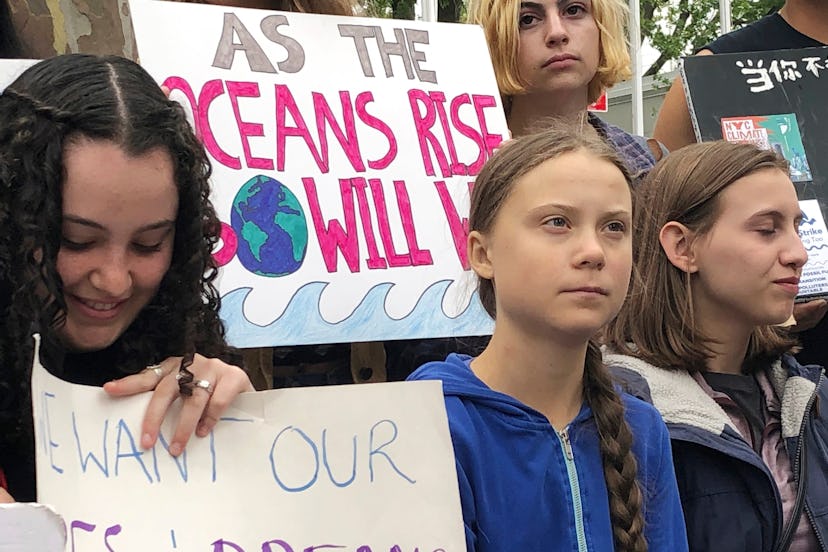 Swedish environmental activist Greta Thunberg, center, participates in a demonstration in front of t...