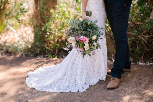 Bohemian bride and groom with big beautiful flower bouquet on wedding day