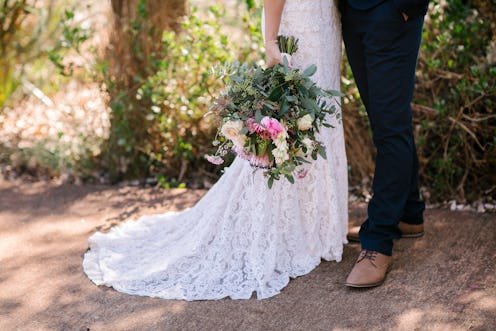 Bohemian bride and groom with big beautiful flower bouquet on wedding day