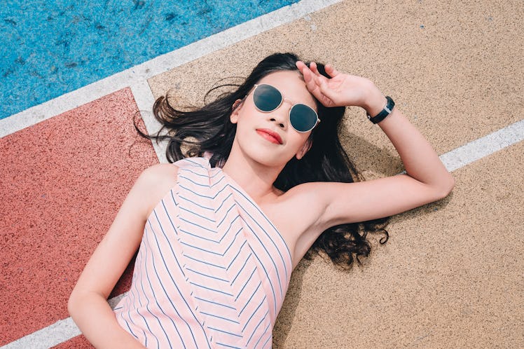 Woman hipster tourist is traveling at colorful basketball court in Choi Hung Estate for holiday vaca...