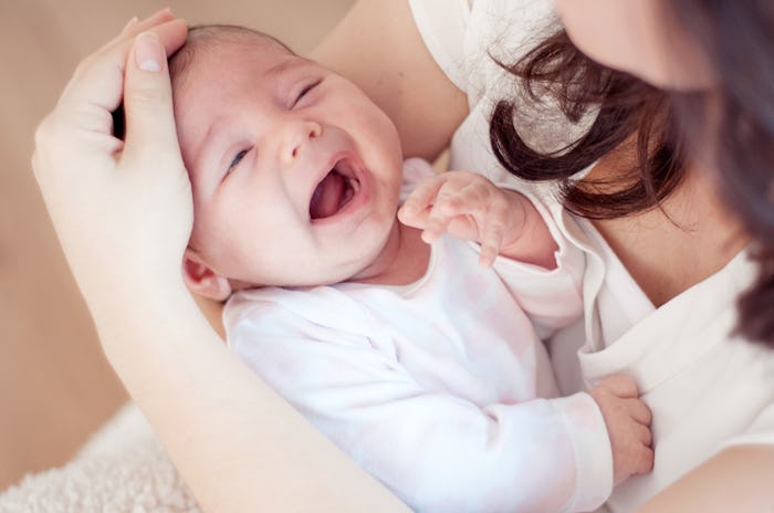 Mother holding her crying newborn