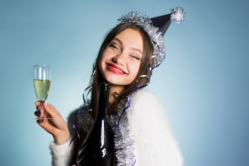 happy woman in festive cap with a glass of champagne