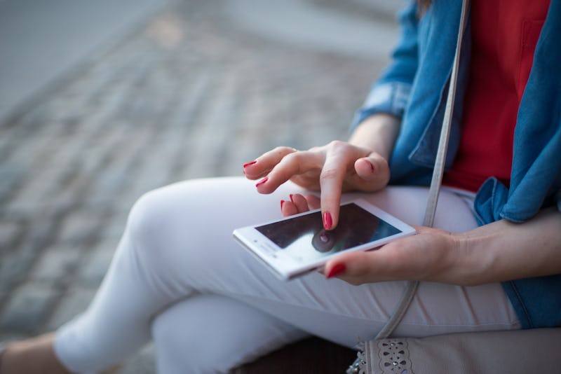 Woman texting. Closeup young happy smiling cheerful beautiful woman girl looking at mobile cell phon...