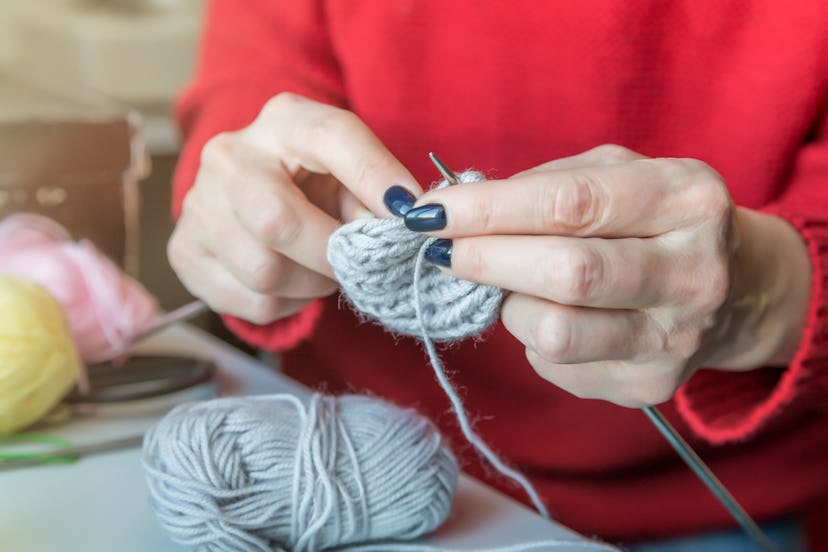 Woman knitting small socks