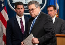 Attorney General William Barr (C) and FBI Deputy Director David Bowdich (L) depart after announcing ...
