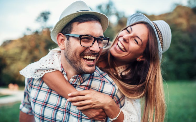 Couple in love. Boyfriend carrying his girlfriend on piggyback. Love and tenderness, dating, romance...