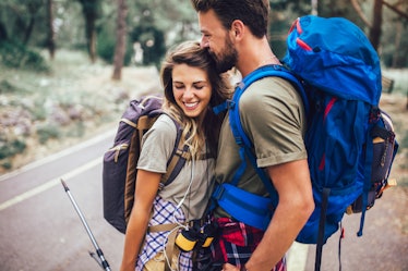 Romantic couple hiking on the path in mountains