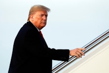 President Donald Trump boards Air Force One at Andrews Air Force Base, Md., en route to a campaign r...