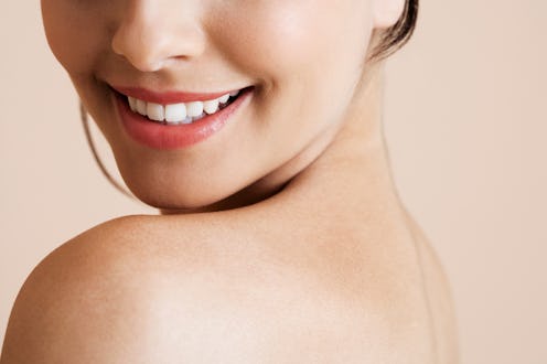 Lower half of a young woman's face, smiling