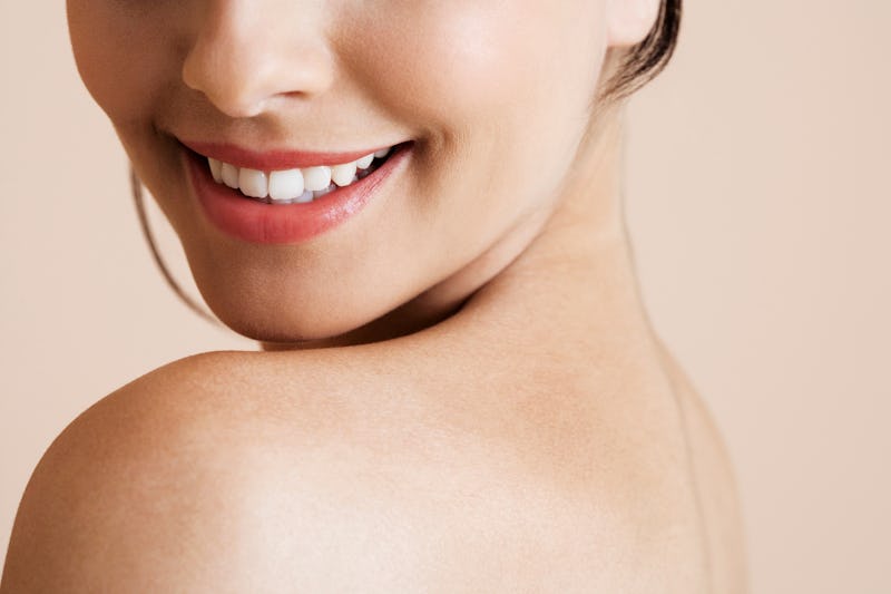 Lower half of a young woman's face, smiling