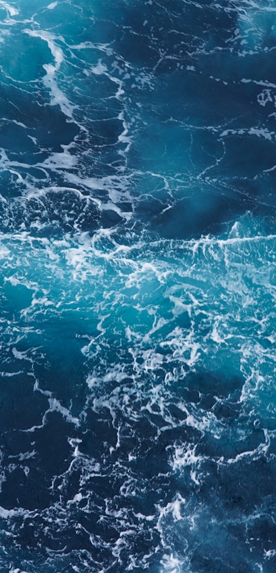  Abstraction of sea foam in the ocean. Dark water, storm waves