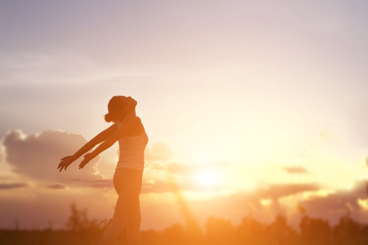 Young woman raise hands up for her success, Concept of Success in life.