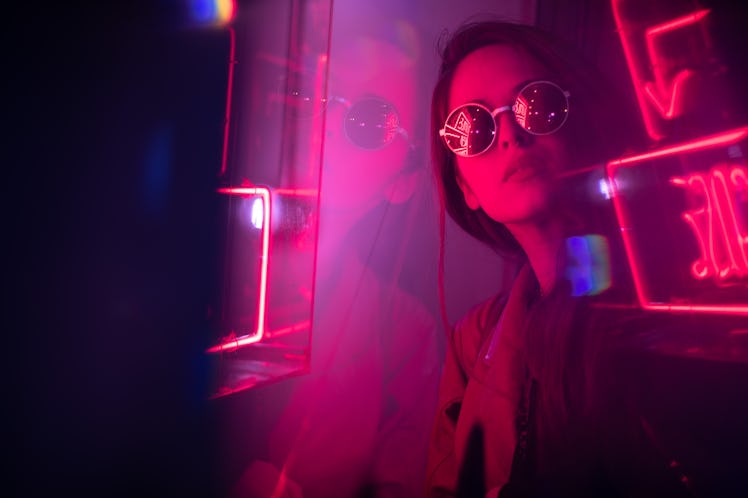 Cinematic night portrait of girl and neon lights