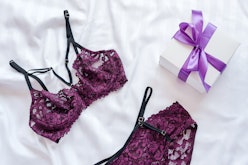 Gift, shopping and fashion concept. Set of glamorous stylish sexy lace lingerie on bed with giftbox ...