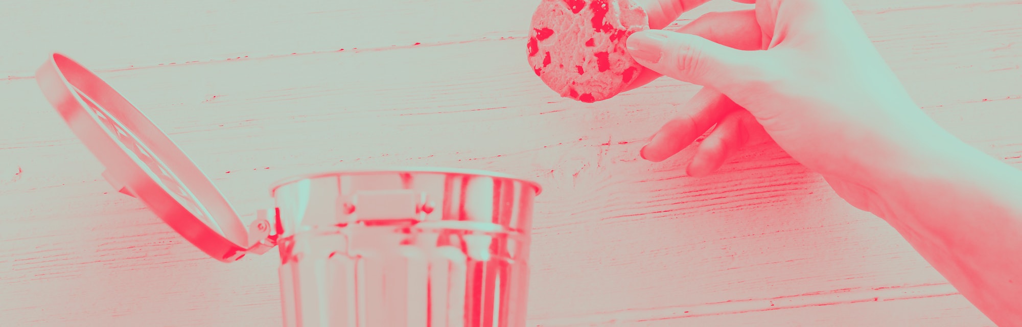 hand throwing cookie into a trash can, metaphor about website cookies and user tracking technologies