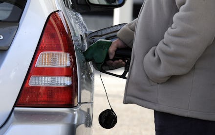 Man fills his car at a petrol pump