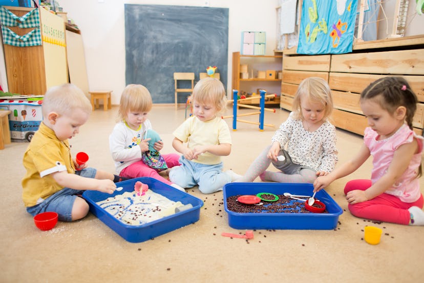 Children improving hands motor skills with rice and beans