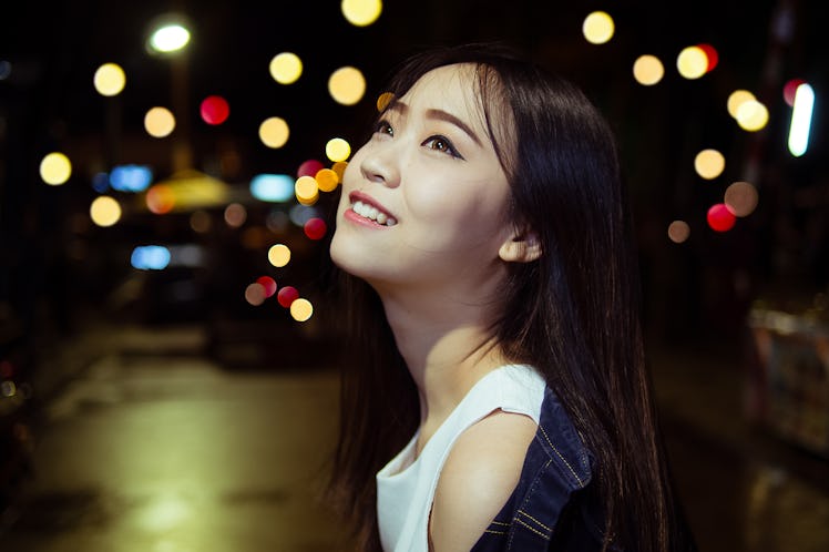 cute asian girl in the night light city with bokeh happiness emotions