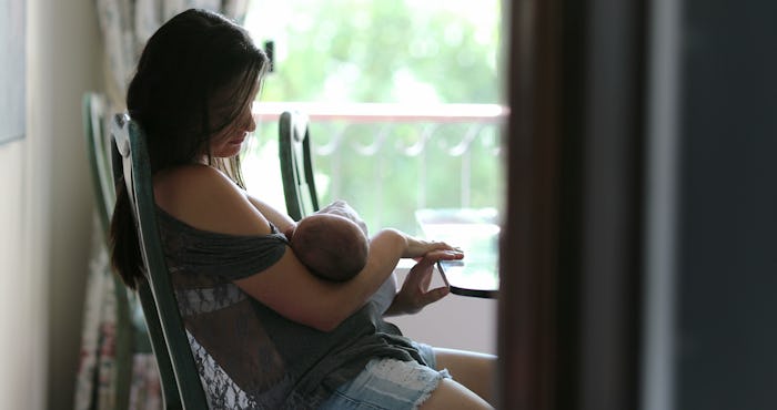 Mother breastfeeding newborn baby infant at home