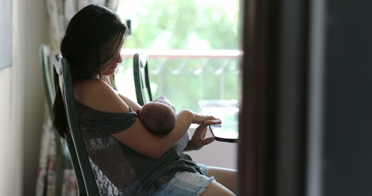 Mother breastfeeding newborn baby infant at home 
