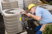 Repairman Works On Air Conditioner Horizontal Shot