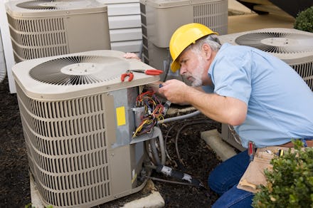 Repairman Works On Air Conditioner Horizontal Shot