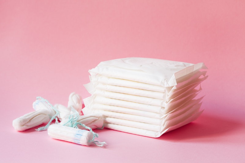 women intimate hygiene products - sanitary pads  and tampons on pink background