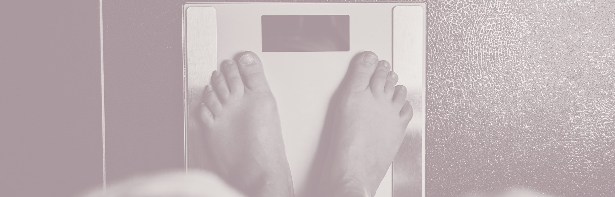 Female bare feet with weight scale, top view