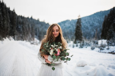girl in a winter forest. bride with a bouquet. girl in winter in the mountains