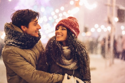 Happy Couple Hugging Celebrating New Year Night Outdoors Standing On A Street Decorated With Winter ...